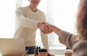 male shaking female hand